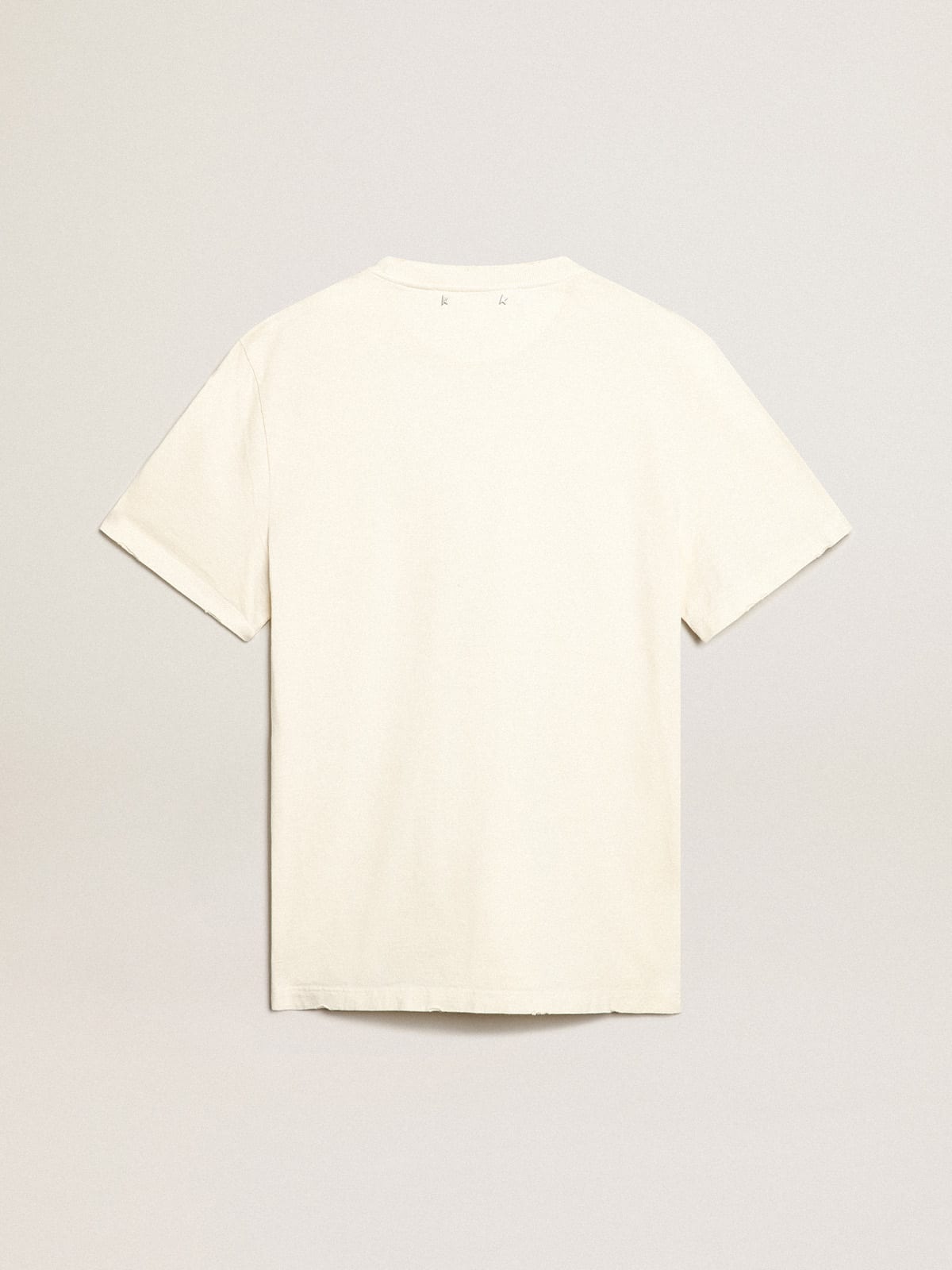 T-shirt di colore bianco dal trattamento distressed con scritta