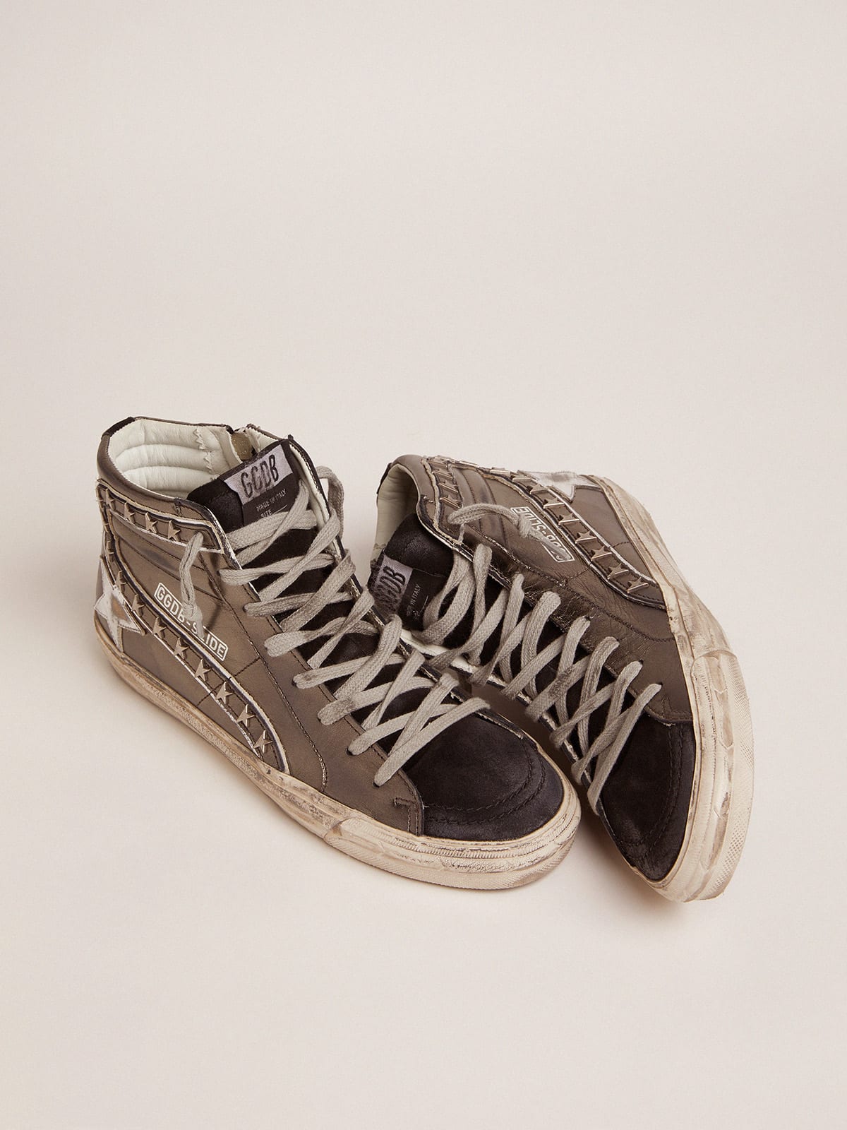 Sneaker Slide con tomaia argento in pelle laminata e borchie a stelle